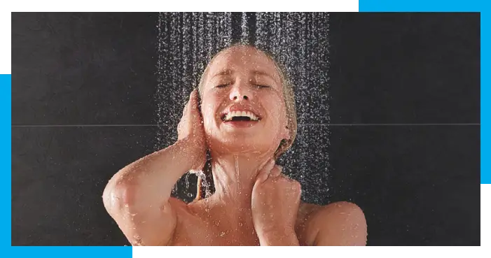 woman enjoying shower because of her condensing hot water heater
